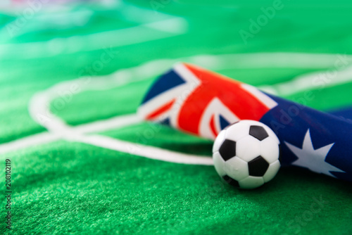 Australia flag and soccer ball on green grass field