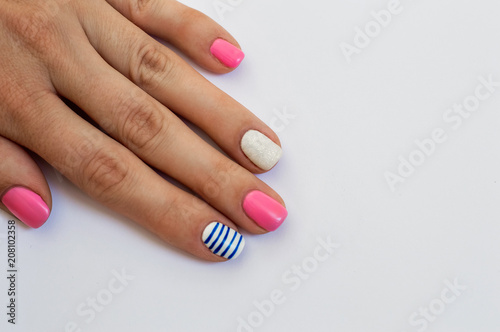 Female hand with a gentle colored manicure on a white background Bright Multicolored Nail Design