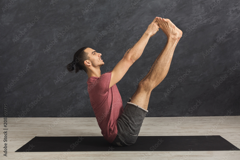 Young man practicing yoga with gymnastic mat Young man practicing yoga with gymnastic mat