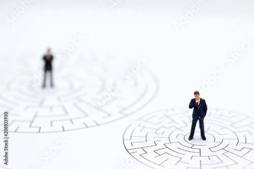 Miniature people : Businessmen in the maze. Image use for to solve problems, finding solution and think new idea concept.
