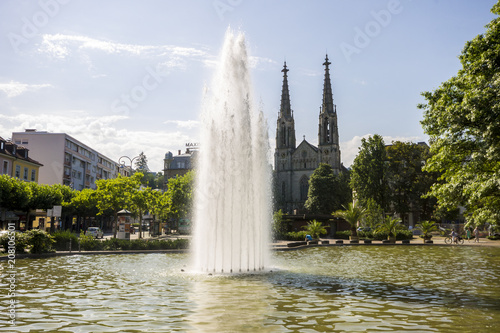 Baden-Baden, Germany. Views of the fountain and pond at Augustaplatz, with the Evangelische Kirche in the background