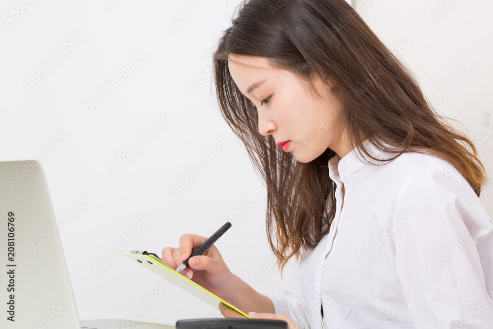 Young business woman working with the documents. The young businesswoman accountant working in the office. Young business woman working with the documents. The young businesswoman accountant working in the office.