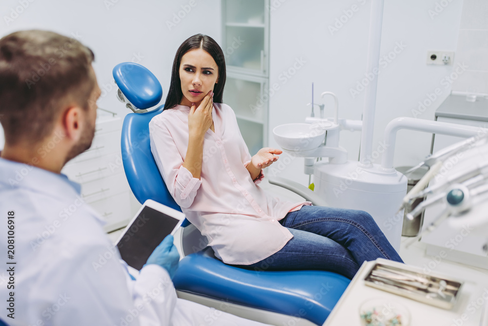 Doctor talking with patient having toothache Doctor talking with patient having toothache