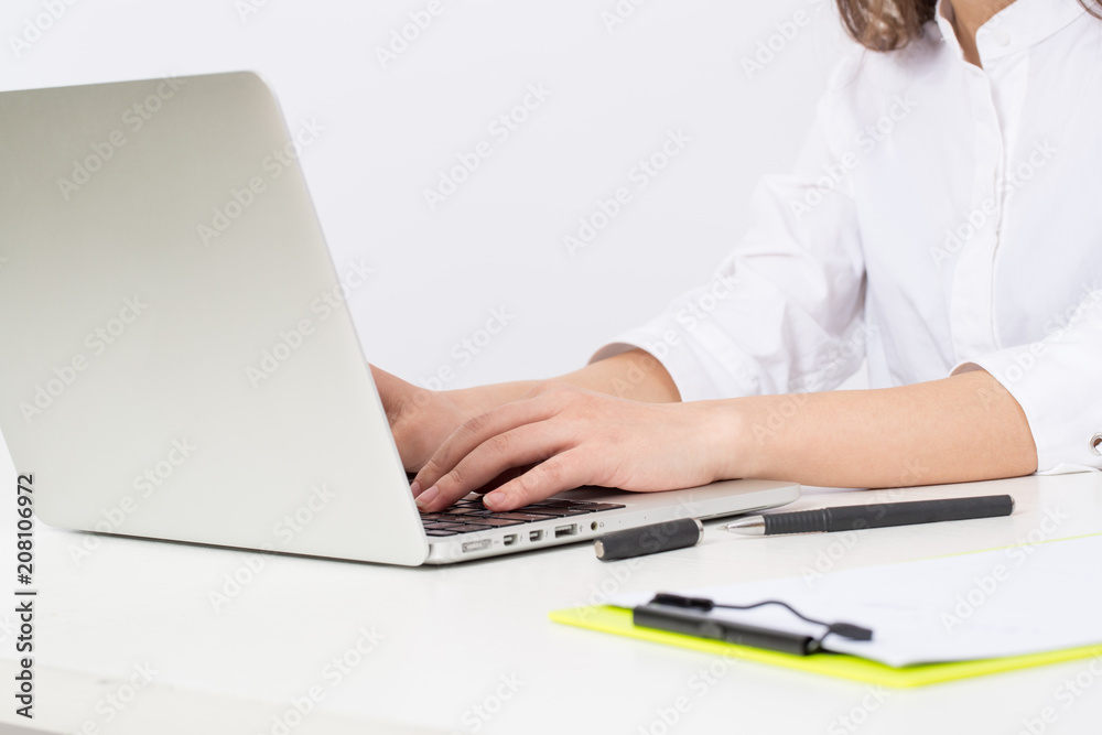 Business young woman typing on laptop computer at office Business young woman typing on laptop computer at office