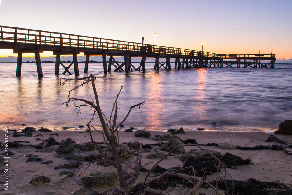 Dock at sunrise in Southport, North Carolina beach vacation destination.