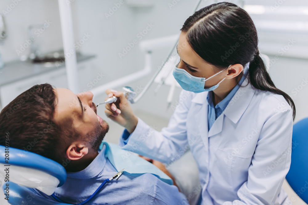 doctor treating patient teeth doctor treating patient teeth