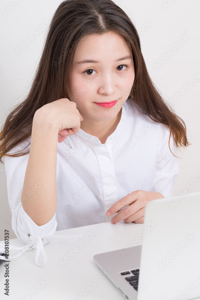 Business woman with laptop computer at office, Close up of smiling young woman working. Business woman with laptop computer at office, Close up of smiling young woman working.