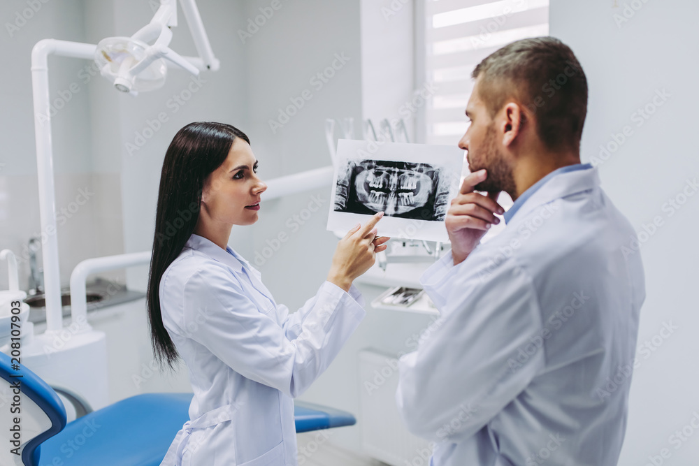 assistant talking with thoughtful doctor assistant talking with thoughtful doctor