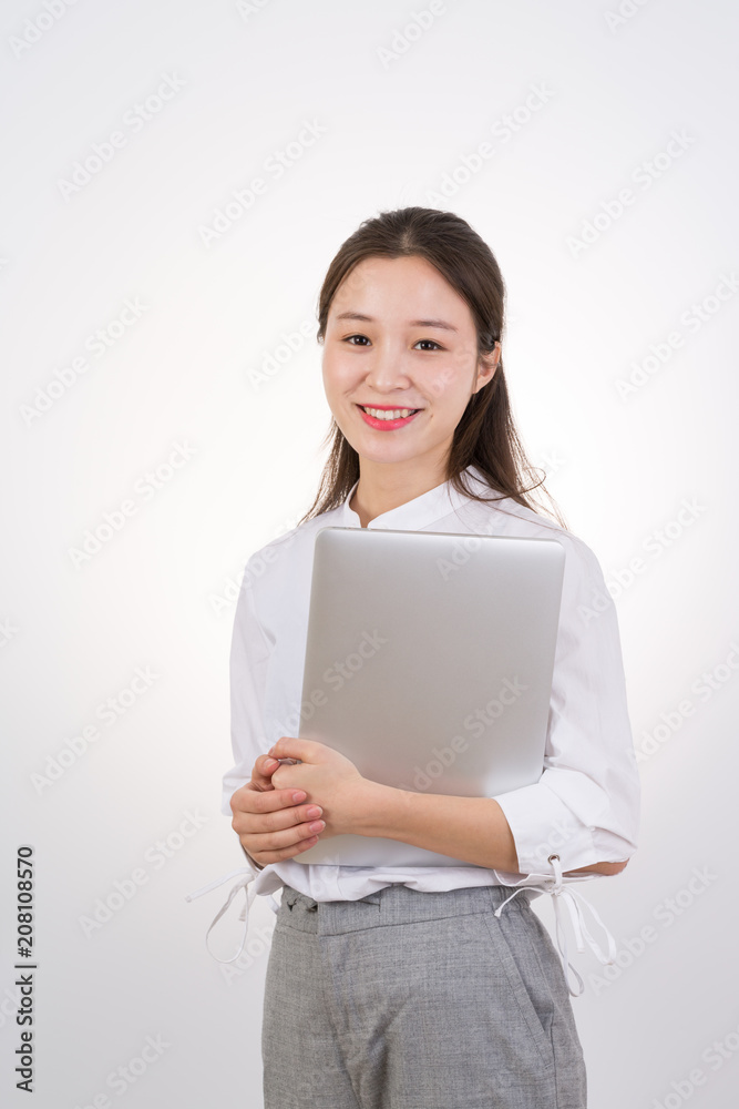 Smiling asian woman in business clothes holding laptop computer Smiling asian woman in business clothes holding laptop computer