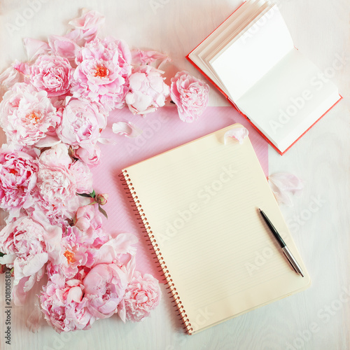 flat lay concept with writing pad, pen, coffee and beautiful peonies, can be used as background 