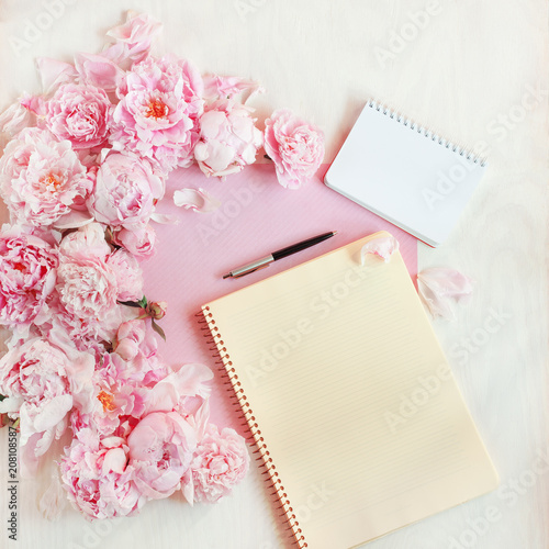 flat lay concept with writing pad, pen, coffee and beautiful peonies, can be used as background 