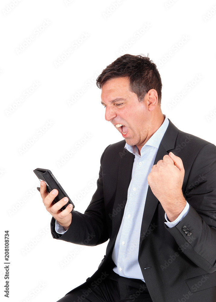 Business man screaming at his cellphone Business man screaming at his cellphone