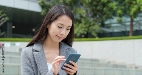 Photography Businesswoman use of smart phone in city
