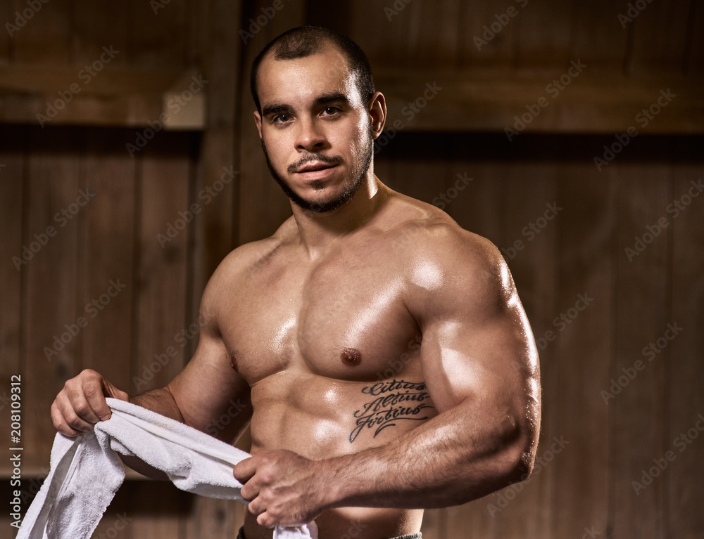 Portrait of confident fit healthy young man holding towel Portrait of confident fit healthy young man holding towel