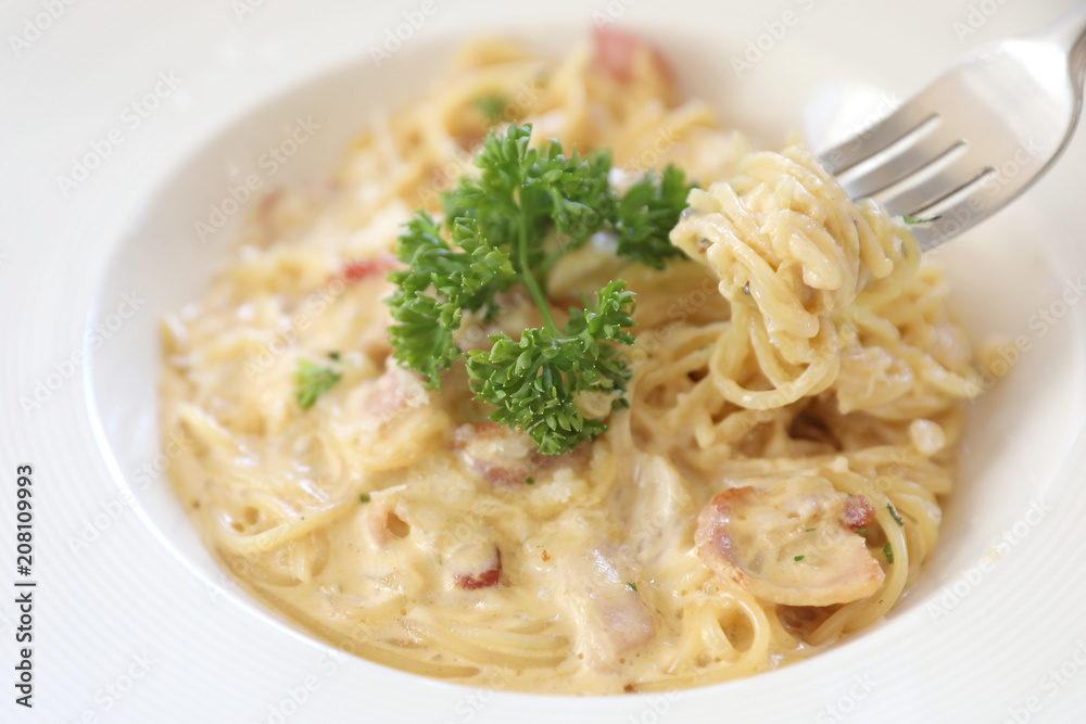 Spaghetti white sauce (Spaghetti Carbonara) with bacon and garlic , on wood table background Spaghetti white sauce (Spaghetti Carbonara) with bacon and garlic , on wood table background