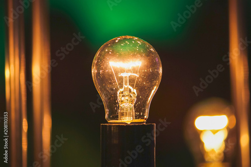 glowing light bulb against blue wall background