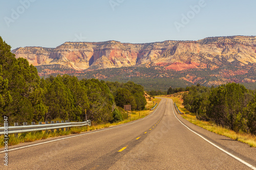 A highway runs along the red-sandstone.