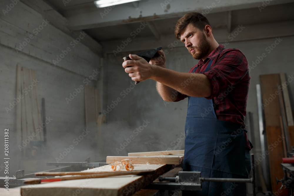 Portrait Male Master carpenter apron in his workshop. Small business Portrait Male Master carpenter apron in his workshop. Small business
