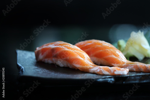 Salmon sushi on black plate japanese food
