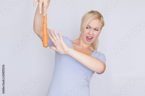 Concept  Blonde does not like carrots. This disgusts her