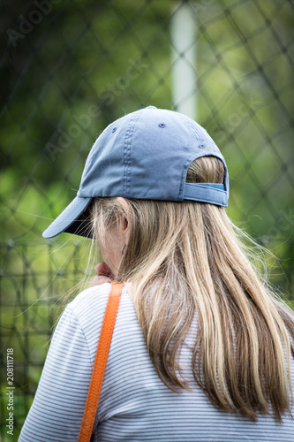 60 years young petite cute slender mature woman with long blond hair and ball cap observing birds in the Florida Keys 
