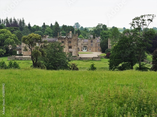 View of Ripley Castle, North Yorkshire, surrounded by trees and green fields