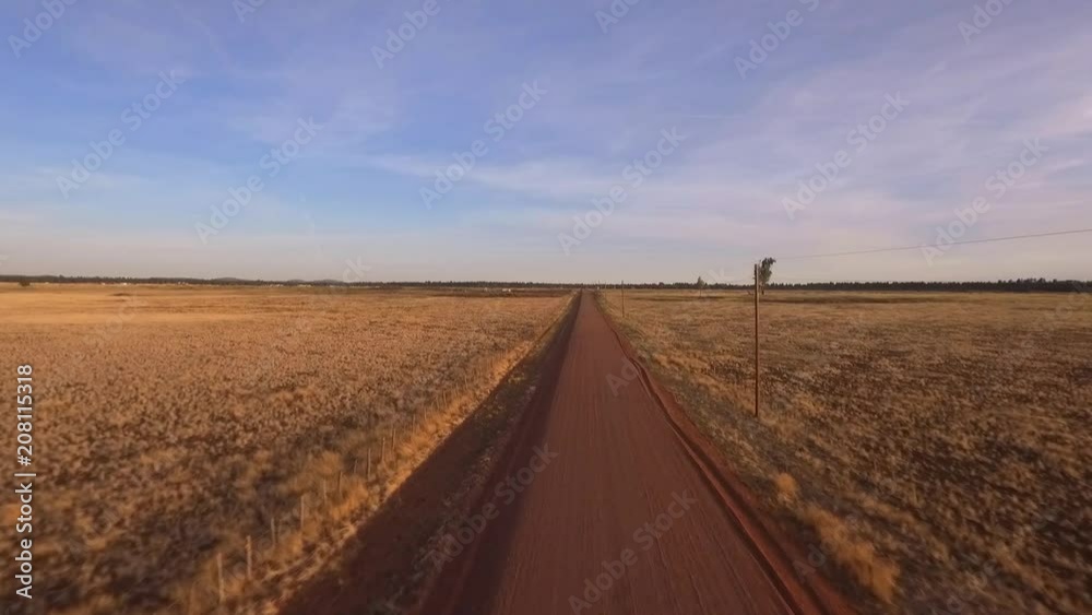 Aerial of a straight gravel road through ranch country Aerial of a straight gravel road through ranch country