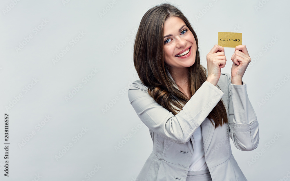 Smiling business woman holding credit card near face. Smiling business woman holding credit card near face.
