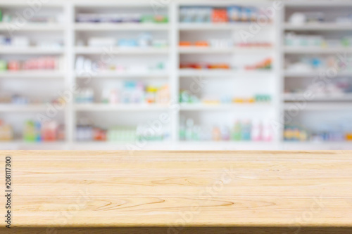 Pharmacy drugstore counter table with blur abstract backbround with medicine and healthcare product on shelves