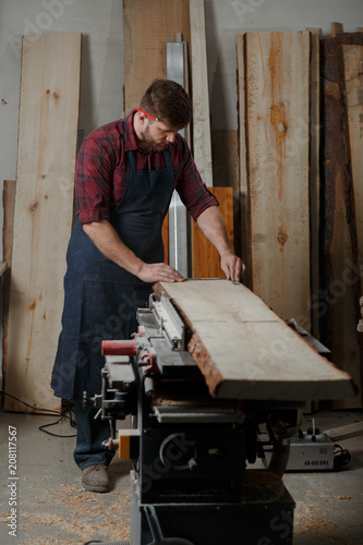 Portrait Male Master carpenter apron in his workshop. Small business