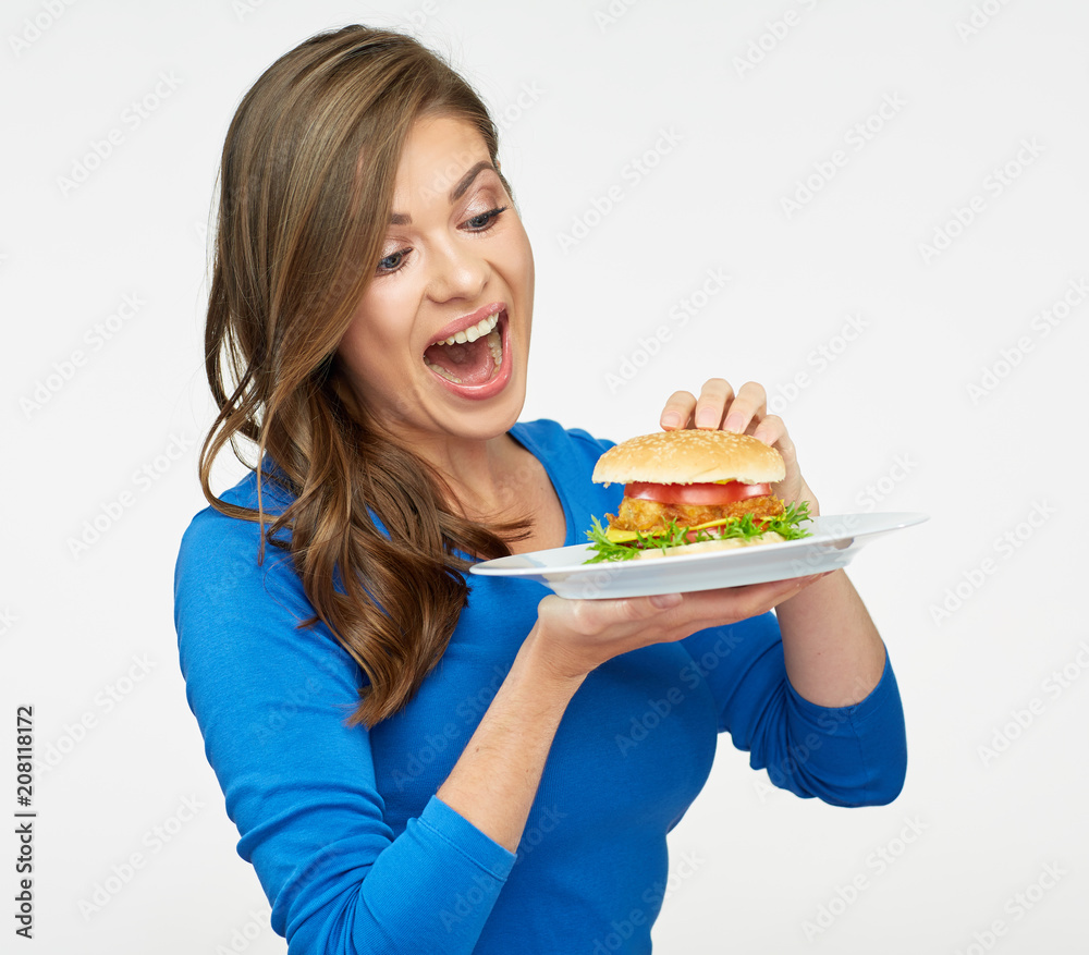 Woman holding white plate with burger. Woman holding white plate with burger.