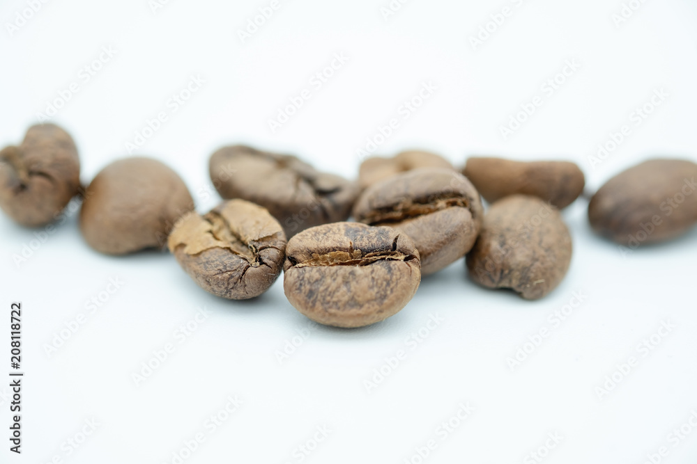 Close up of pile of coffee bean on white background. Close up of pile of coffee bean on white background.