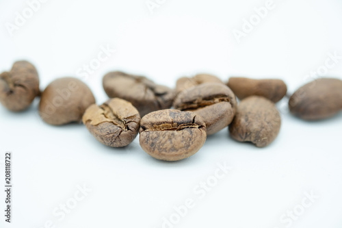 Close up of pile of coffee bean on white background.