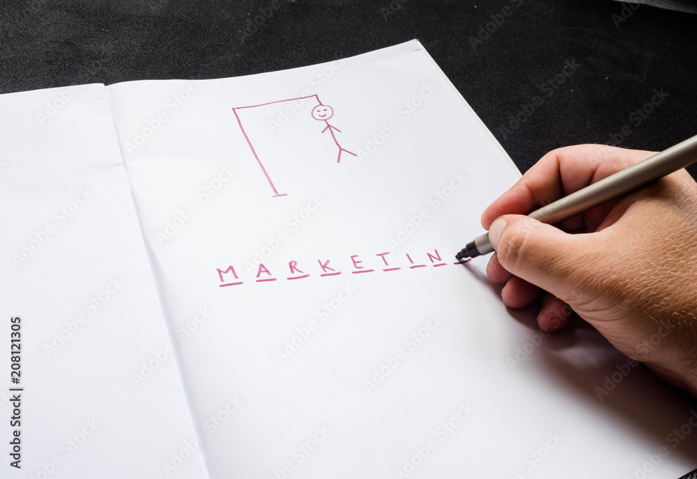 hangman traditional game. hand with marker, highlighter writes word marketing hangman traditional game. hand with marker, highlighter writes word marketing