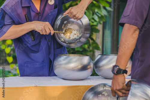 To make merit by offering food to monk ceremony in Thai wedding tradition