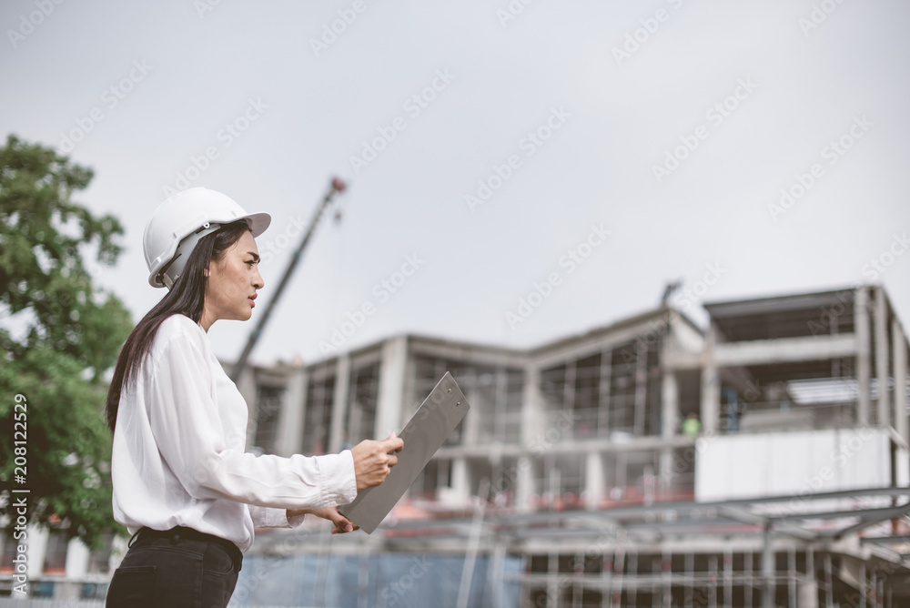 Fototapeta premium Asian women worker and engineer electrician work safety control at power plant energy industry
