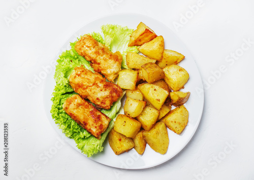 Fish and chips on a plate, white background, top view