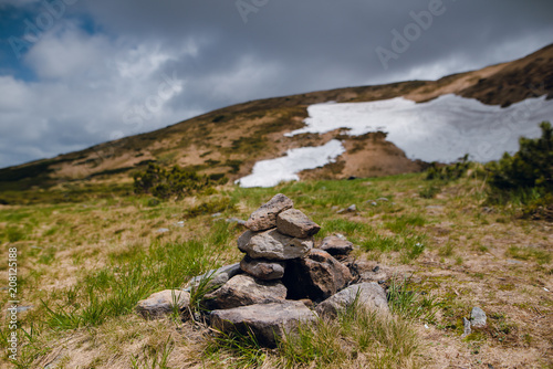 Close up pyramid of the stones on the hill with melting snow. Spring in Carpathian mountains, Ukraine © WellStock