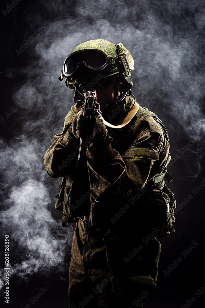 russian special forces soldier with rifle on dark background. army, military and people concept russian special forces soldier with rifle on dark background. army, military and people concept
