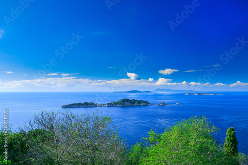 Beautiful summer seascape. Awesome view picturesque green hills coastline sea bay with crystal clear azure water, distant islands in the calm warm sea. Agios Stefanos cape. Afionas. Corfu. Greece.
