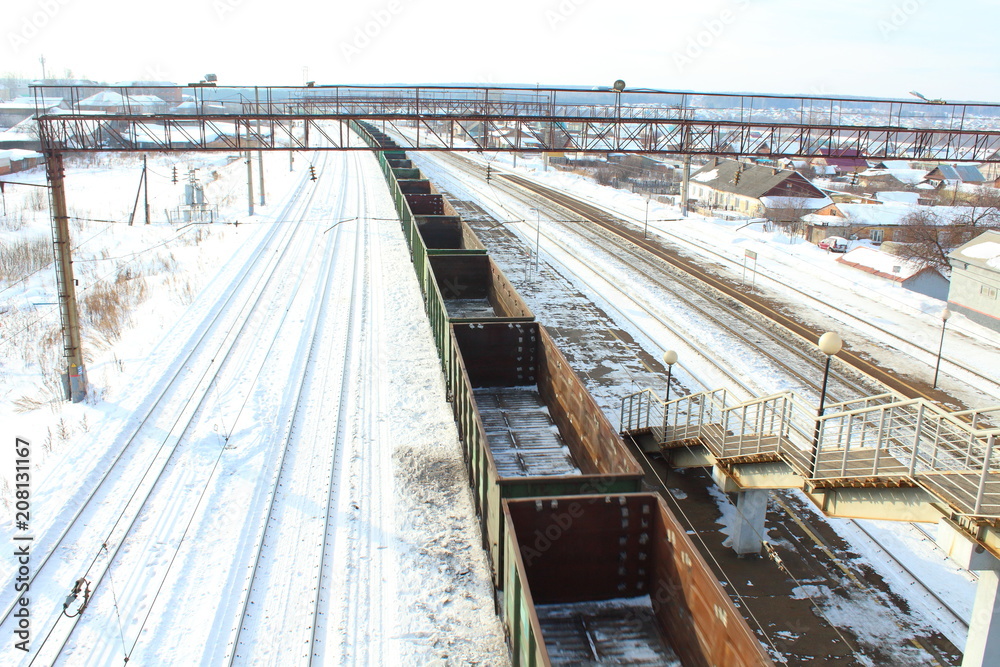 Empty freight cars from the train at the railway station. Freight composition. Russia, February, 2018.