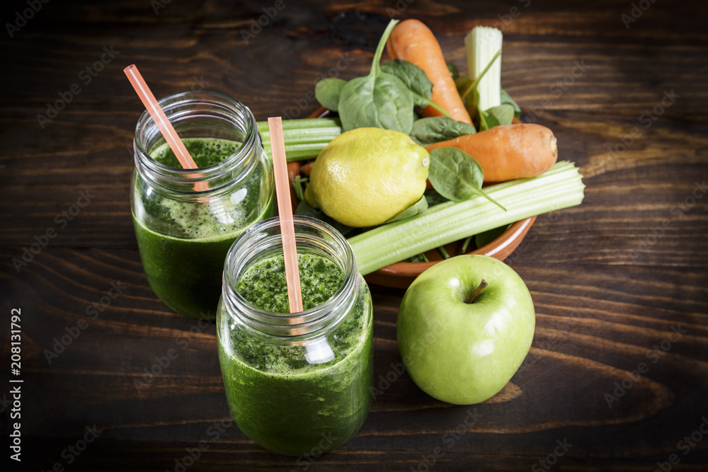 Spinach with apple and vegetables juice a soft drink jar with straw on wooden table Spinach with apple and vegetables juice a soft drink jar with straw on wooden table