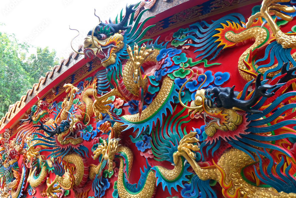 chinese dragon statue at the wall of temple in Thailand chinese dragon statue at the wall of temple in Thailand
