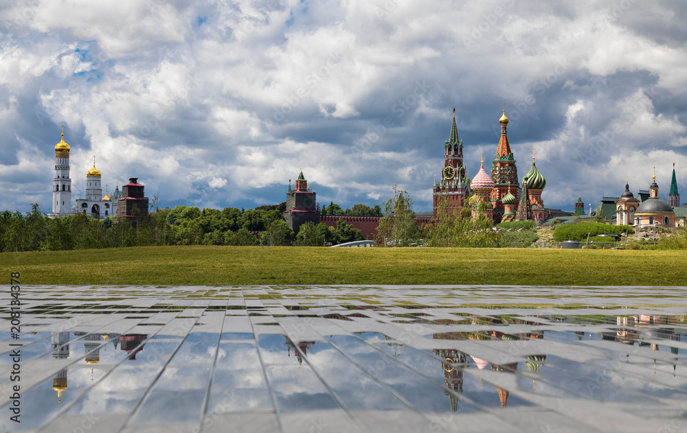 View from the hill of the Zaryadye park on church Ivan the Great Bell Tower and Kremlin with  reflections. Cloudy weather with thunderclouds on a background