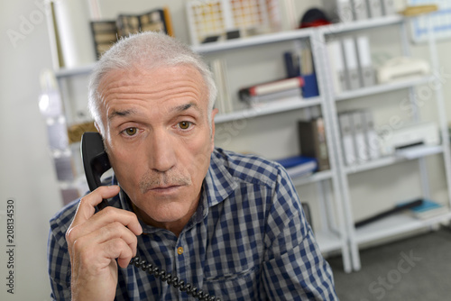 Man on telephone, surprised expression