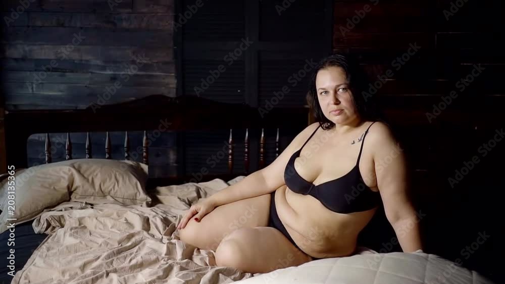1000px x 563px - Sexy fat woman with obesity is sitting on the bed in a dark room. Fat folds  and cellulite Stock Video | Adobe Stock