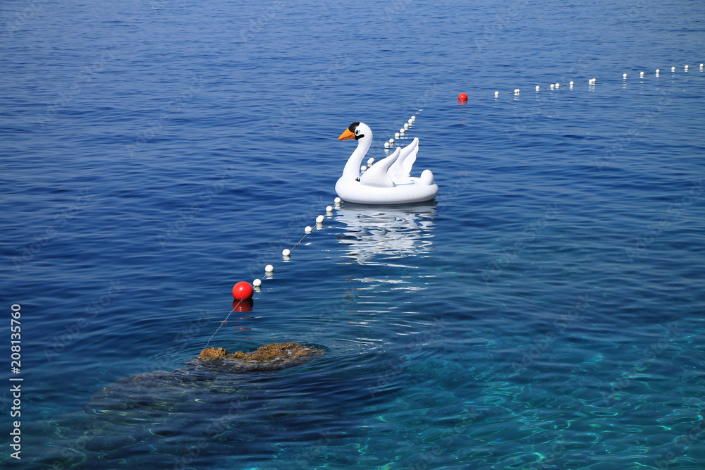 Inflatable white swan float in Adriatic sea , Croatia