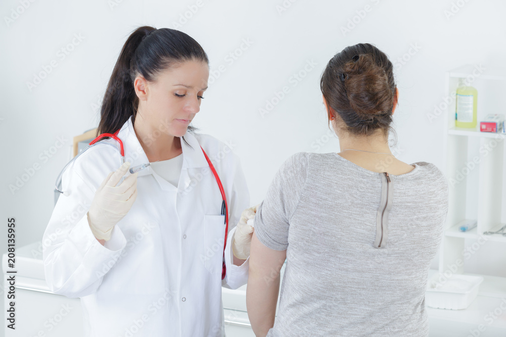 doctor examining her patients stomach in medical office doctor examining her patients stomach in medical office