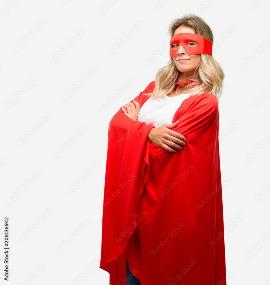 Young super hero woman wearing cape with crossed arms confident and happy with a big natural smile laughing