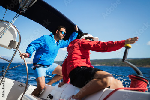 Attractive strong woman sailing with her boat